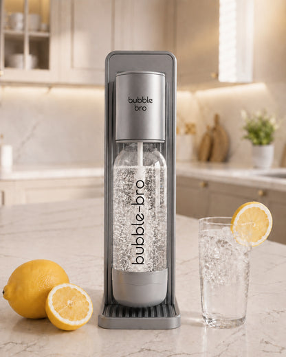 Bubblebro sparkling water maker in black on a kitchen counter with fresh lemons and a glass of fizzy water 